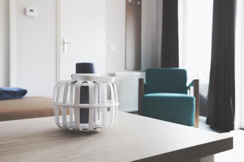 a glass object on a table with two blue chairs at Lodgepark Goitzsche GmbH in Große Mühle