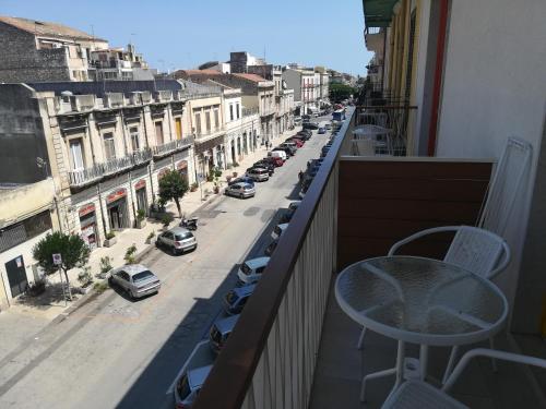 a balcony with a view of a city street at Archinuè in Siracusa