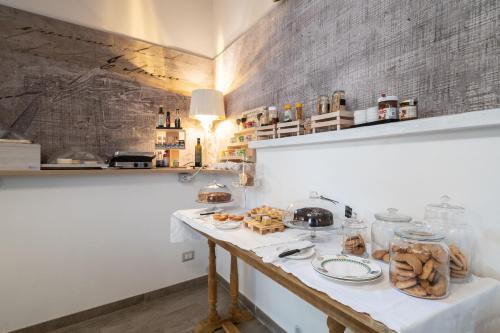 a kitchen with a table with plates of food on it at Cas'E Charming House in Caserta