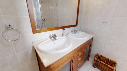 a bathroom with two sinks and a mirror at Casa Sofia in Costa Calma