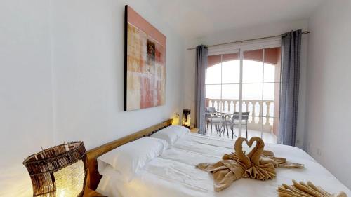 a bedroom with a bed and a window and a table at Casa Sofia in Costa Calma