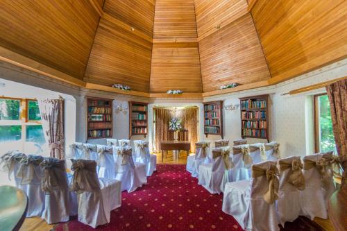 a row of chairs in a room with books at Glen-Yr-Afon House Hotel in Usk