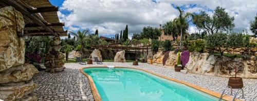 The swimming pool at or close to Il Giardino dei Flintstones B&B