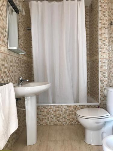 a bathroom with a sink and a toilet and a shower at Aires de Mar in Playa Honda
