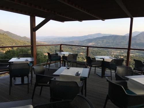 a restaurant with tables and chairs on a deck at Best Western Plus San Damianu in Sartène