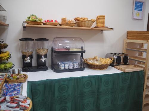 a counter with a green cabinet with food on it at Hotel La Terraza in Miño