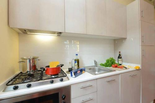 a kitchen counter with a stove and a sink at Villa Verganti Veronesi in Inveruno