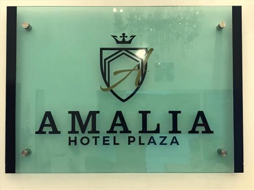 a sign for a malia hotel plaza at Hotel Plaza Amalia in Tuxtla Gutiérrez
