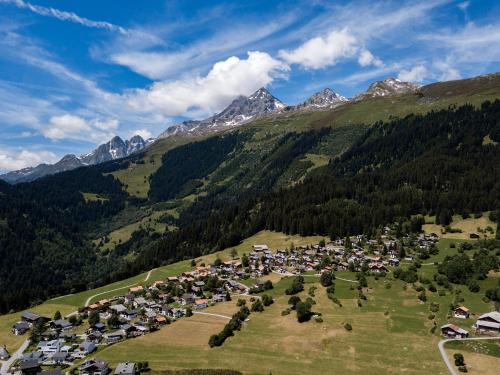 an aerial view of a village in the mountains at Hotel Mischun in Brigels