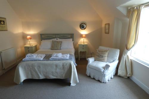 a bedroom with a bed and a chair at Abbey View in Kelso