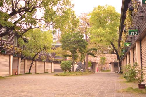 an empty street in a city with trees and buildings at Ivy Motel in Chiayi City