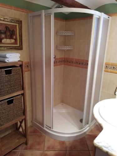 a shower with a glass door in a bathroom at Casa Tiretes in Morella