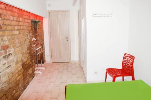 a room with a green table and a brick wall at Hostel Train Station in Kyiv