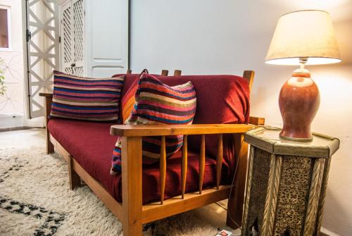 a living room with a couch and a lamp at Riad Dar Latigeo in Essaouira