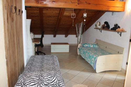 a bedroom with a bed and a desk in it at Villetta relax in Aosta