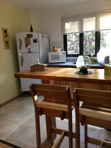 a kitchen with a wooden counter top with a refrigerator at 678 Mascardi Roca Malen in San Martín de los Andes