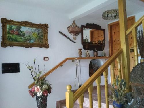a room with a staircase and a mirror on the wall at Karafil Guesthouse in Gjirokastër