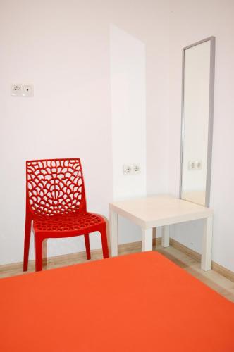 a room with a chair and a table and a mirror at Hostel Train Station in Kyiv