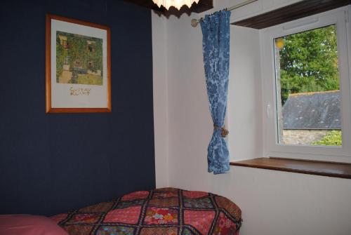 Maël-PestivienにあるMaison De Familleのベッドと窓のある寝室