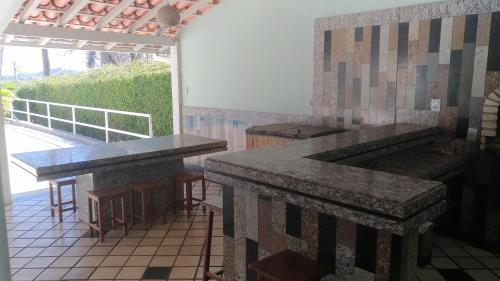 a kitchen with granite counter tops and a patio at Casa em Escarpas do Lago in Capitólio