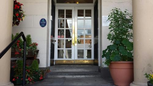 an entrance to a building with a door and a potted plant at George and Abbotsford in Melrose