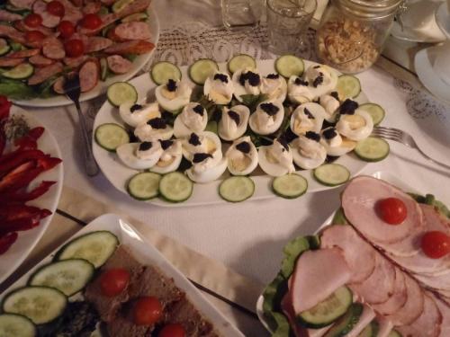 a table with several plates of food on it at Hotel Orlik in Płońsk