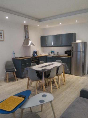 a kitchen with a table and chairs in a room at Sohosuite in Lille