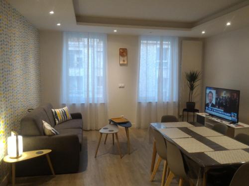 a living room with a couch and a table at Sohosuite in Lille