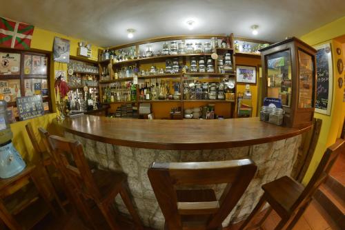 a bar with a wooden counter in a room at La Casa de Zarela in Huaraz
