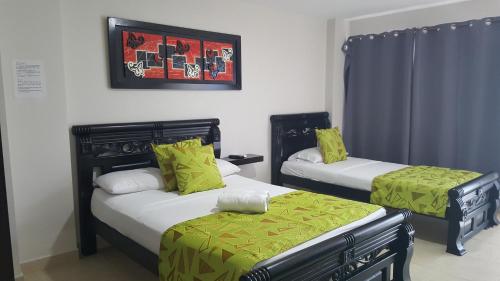 Ліжко або ліжка в номері Caribbean Island Hotel Piso 2