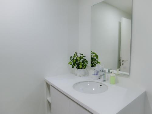 a white bathroom with a sink and a mirror at Unlisted-Harmony in Petaling Jaya