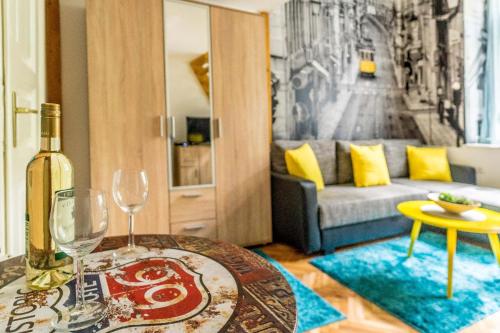 a living room with a bottle of wine and a table at Mystic Apartment in Budapest