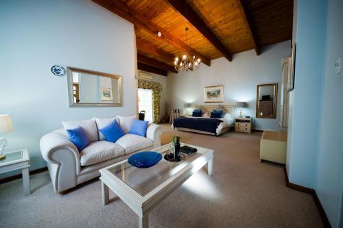 a living room with a couch and a table at Le Manoir de Brendel in Franschhoek