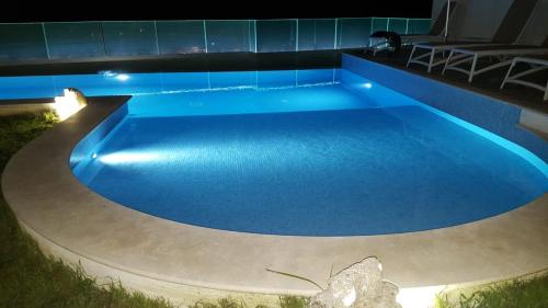 a swimming pool at night with blue lighting at Appartamenti Borgo Panoramico n.1 in Tropea