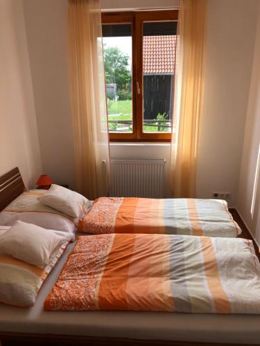 een bed in een slaapkamer met een raam bij s'Schnoganeschd in Nemesvid