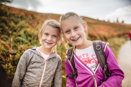 two little girls standing next to each other at Aparthotel DAS Hochkönig in Ramsau am Dachstein