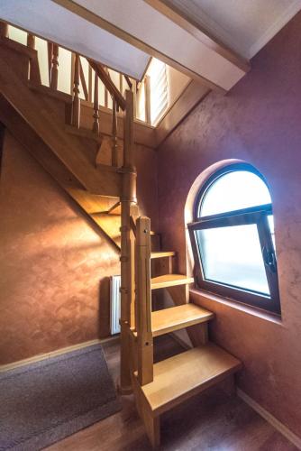 a spiral staircase in a room with a window at Talismano Apartments in Smederevo