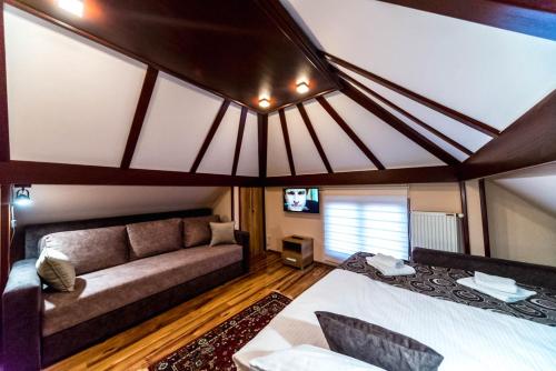 a living room with a couch and a bed in a room at Talismano Apartments in Smederevo
