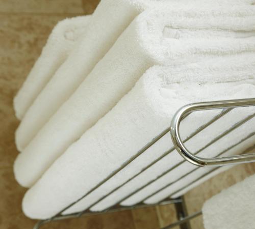 a pile of white towels on a towel rack at Grand Hotel Sunderland in Sunderland