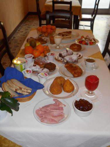 a table with many plates of food on it at Antico Palazzo in Giardini Naxos