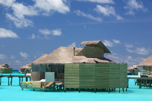 a small hut on the water in the ocean at Six Senses Laamu in Laamu Atoll