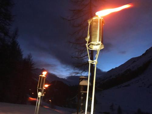 a pair of street lights in the snow at night at Apartment Gletscherbergblick in Obergurgl