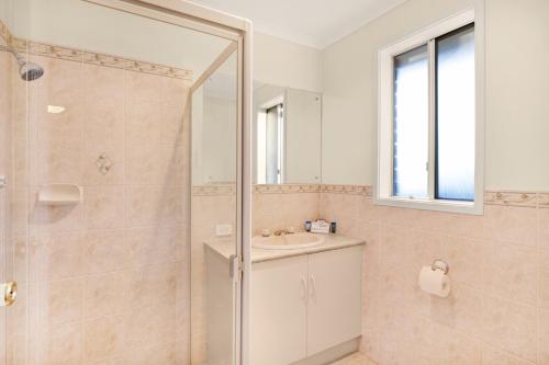 a bathroom with a shower and a sink at Adelaide Road Motor Lodge in Murray Bridge