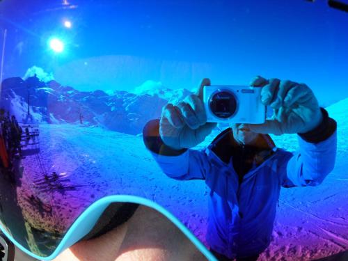 a person taking a picture with a camera at Snežak (Snowman) 2 in Bohinj