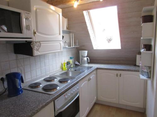 a small kitchen with a sink and a stove at Ferienwohnung Regina in Albstadt