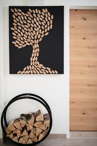 a painting of a tree on a wall next to a mirror at Chalet Ana Bohinj in Bohinj
