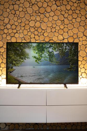 a television screen with a picture of a lake at Chalet Ana Bohinj in Bohinj