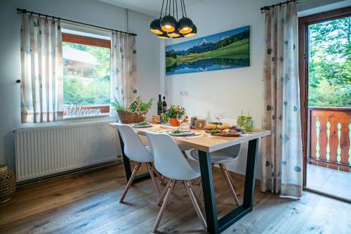 a dining room with a table and chairs and a window at Chalet Ana Bohinj in Bohinj
