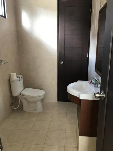 a bathroom with a toilet and a sink at Kensington Villa in Bongkor 1