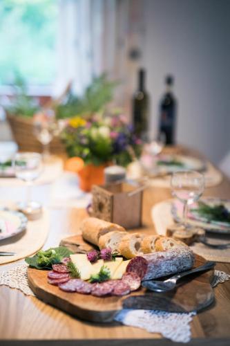 a wooden table with a cutting board with food on it at Chalet Ana Bohinj in Bohinj